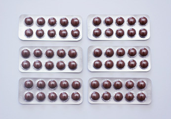 Brown pills plastic blisters pattern set on white background.