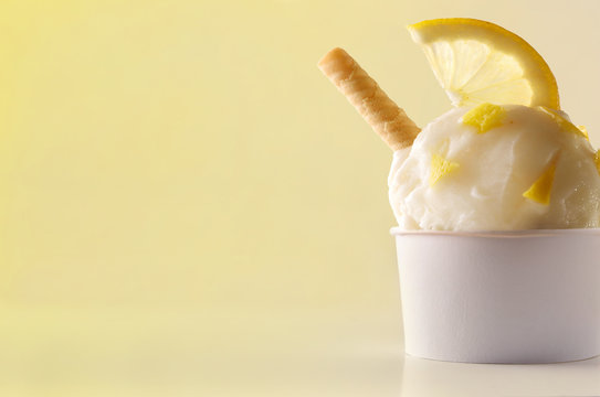 Lemon ice cream cup on table isolated close up