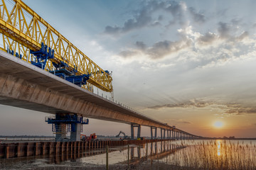 Crown Princess Mary bridge and a construcion crane in the sunrise