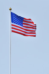 A beautiful and bright flag of the United States of America against the sky.