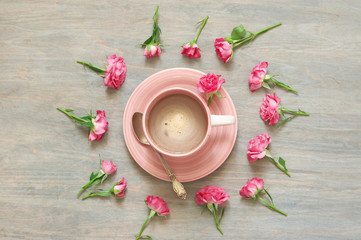 Fototapeta na wymiar Cup of creamy coffee with flowers decor