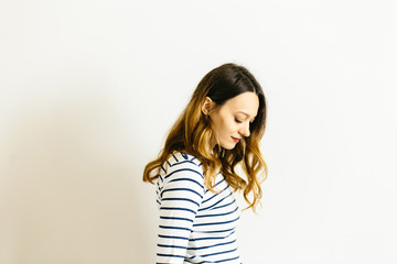 Pretty girl in a striped t-shirt on a white background