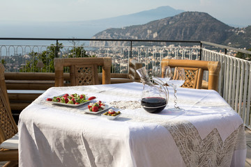 Prepared for supper table on the terrace overlooking the Bay of Naples and  Vesuvius. Sorrento. Italy
