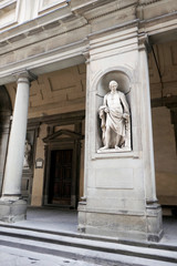 Statue of Niccola Pisano in the niches of the Uffizi Gallery colonnade, Florence.