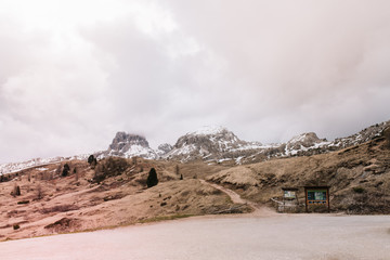 Photo of deserted landscape of Italy with distant mountains and overcast sky. Little path leading...