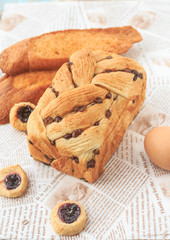 Bread, milk, eggs and fruit are on the table