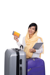 muslim woman with tablet suitcase and passport ready for traveling over white background