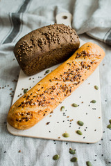 Freshly baked bread on dark grey fabric with seed