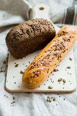 Freshly baked bread on dark grey fabric with seed