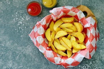 Homemade french fries with mustard and tomato sauce.