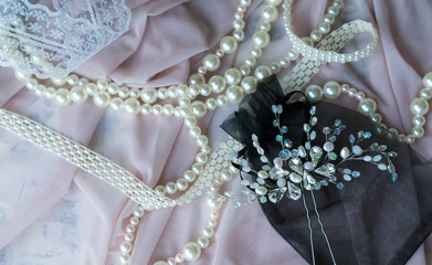 Wedding background with pearls and hair accessories on pink background