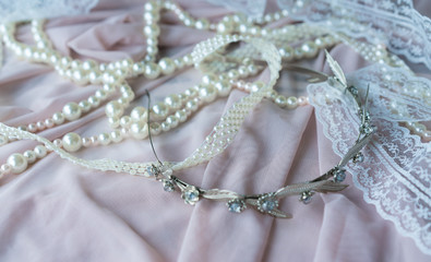 Wedding background with pearls and hair accessories on pink background
