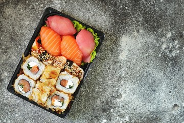 Sushi set with salmon, soft cheese, tuna, smoked eel. Sushi delivery to home. Healthy food. Top view. 