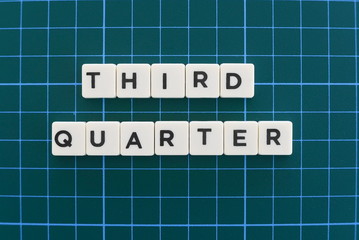 Third quarter word made of square letter word on green square mat background.