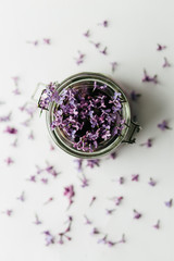 healthy smoothie breakfast in a glass jar with lilac flowers