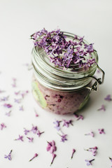 healthy smoothie breakfast in a glass jar with lilac flowers