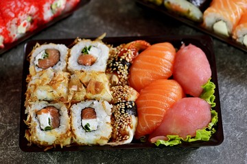 Sushi set with salmon, soft cheese, tuna, smoked eel. Sushi delivery to home. Healthy food. 