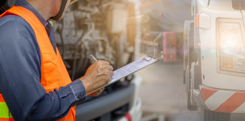 Preforming a pre-trip inspection on a truck,Concept preventive maintenance truck checklist,Check truck engine,Check the lubricating oil,spot focus.