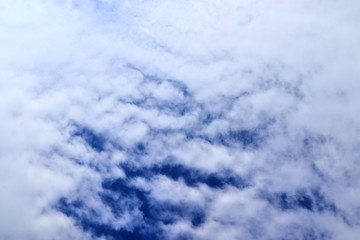 Beautiful white fluffy clouds on a deep blue sky in high resolution