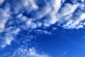 Beautiful white fluffy clouds on a deep blue sky in high resolution