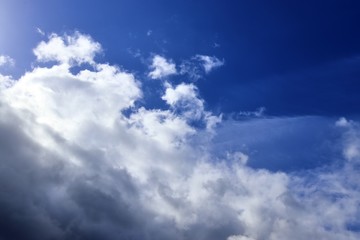 Beautiful white fluffy clouds on a deep blue sky in high resolution