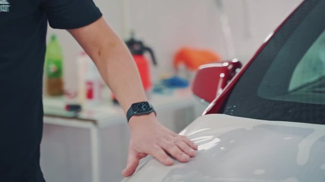 Protective film on hood of car. Close up of pasting protective film of the automobile