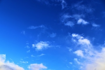Beautiful white fluffy clouds on a deep blue sky in high resolution
