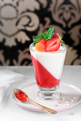 Panna Cotta with strawberry mousse on retro background