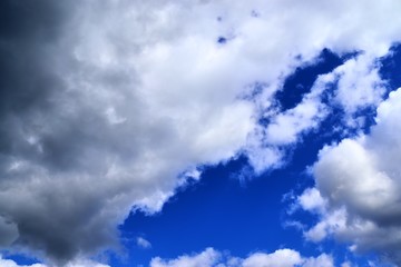 Beautiful white fluffy clouds on a deep blue sky in high resolution