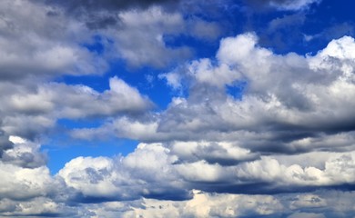 Beautiful white fluffy clouds on a deep blue sky in high resolution