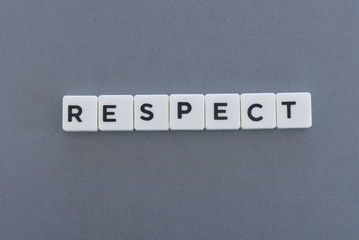 Respect word made of square letter word on grey background.