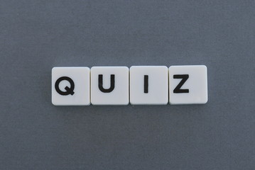 Quiz word made of square letter word on grey background.