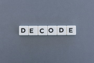 Decode word made of square letter word on grey background.