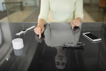 technology and people concept - close up of woman using black interactive panel