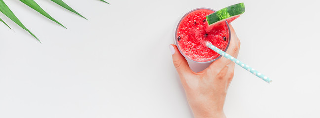 Woman hands with watermelon smoothie drink glass