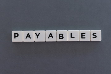Payables word made of square letter word on grey background.