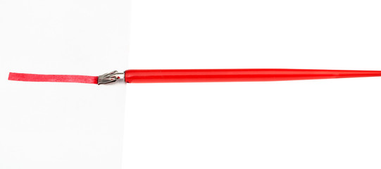 side view of dip pen drawing red line by wide nib