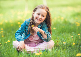 Little girl collecting flowers