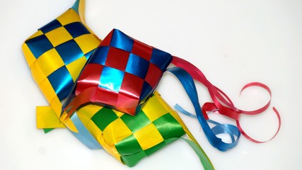 Ketupat ribbon in white background / Origin of Ketupat - A traditional rice wrapped by leaf and to be consume at the period of Hari Raya.(selective focus and soft focus).