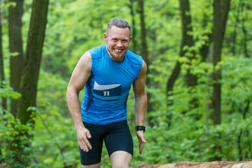 Fototapeta premium Young sporty man running trail cross in the forest