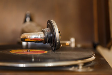 Retro gramophone with vinyl disc on it