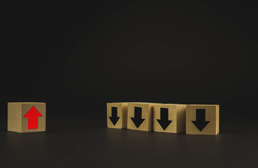 Hand putting wood cube block on top pyramid wooden blocks with red arrows facing opposite to the...