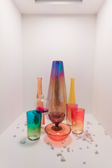 Set of glasses and vases of colored glass on a white background.