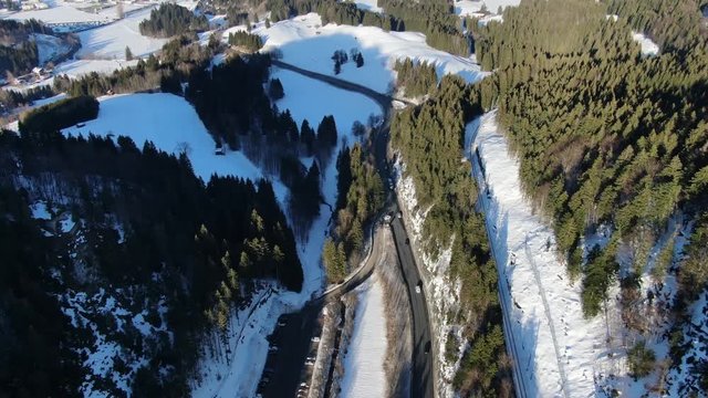 Long road with lots of traffic, sunny winter day in the mountains, 4k