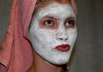 Cosmetic white face mask of toothpaste. Woman in white cosmetic mask