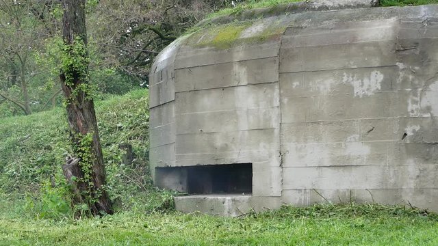 The machine gun shoots from the embrasure of the bunker. Long-term defensive point. Installation of combat defensive pillbox. The turn of defense 1941 with. Bilogorodka. Kiev. Ukraine. May 08, 2019