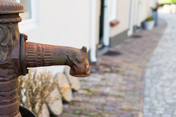 old rusty water pump in street of Oudewater, The Netherlands