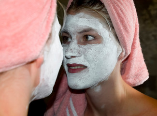 Cosmetic white face mask of toothpaste. Woman in white cosmetic mask