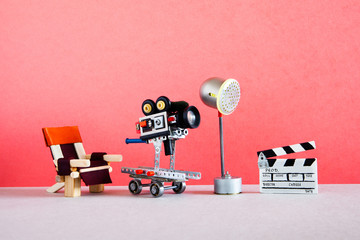 Filmmaking behind the scenes. Motion picture backstage studio area with director's chair, camera or...