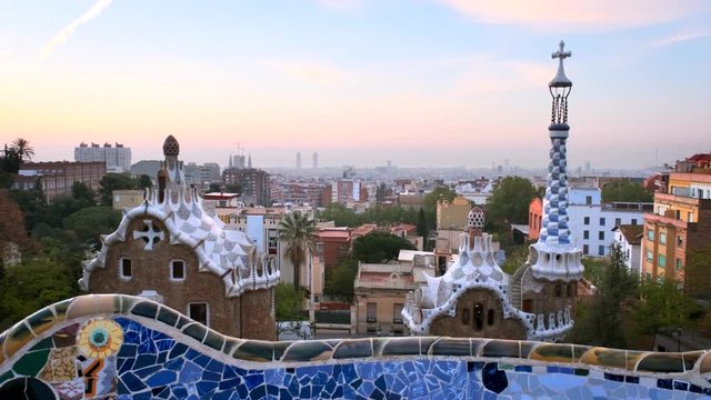 Barcelona city view from Guell Park. Sunrise view of colorful mosaic building in Park Guell.